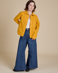 Hana is wearing Denim Work Jacket in Mustard Yellow and dark wash Indigo Wide Leg Trousers