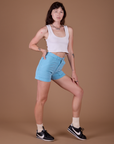 Angled front view of Classic Work Shorts in Baby Blue and Cropped Tank in Vintage Off White on Alex
