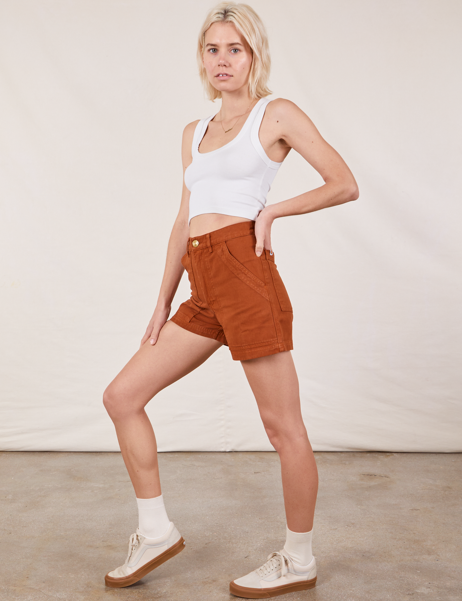 Side view of Classic Work Shorts in Burnt Terracotta and Cropped Tank Top in vintage tee off-white on Madeline