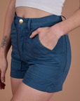 Close up of Alex's hand in the front pocket of Classic Work Shorts in French Blue