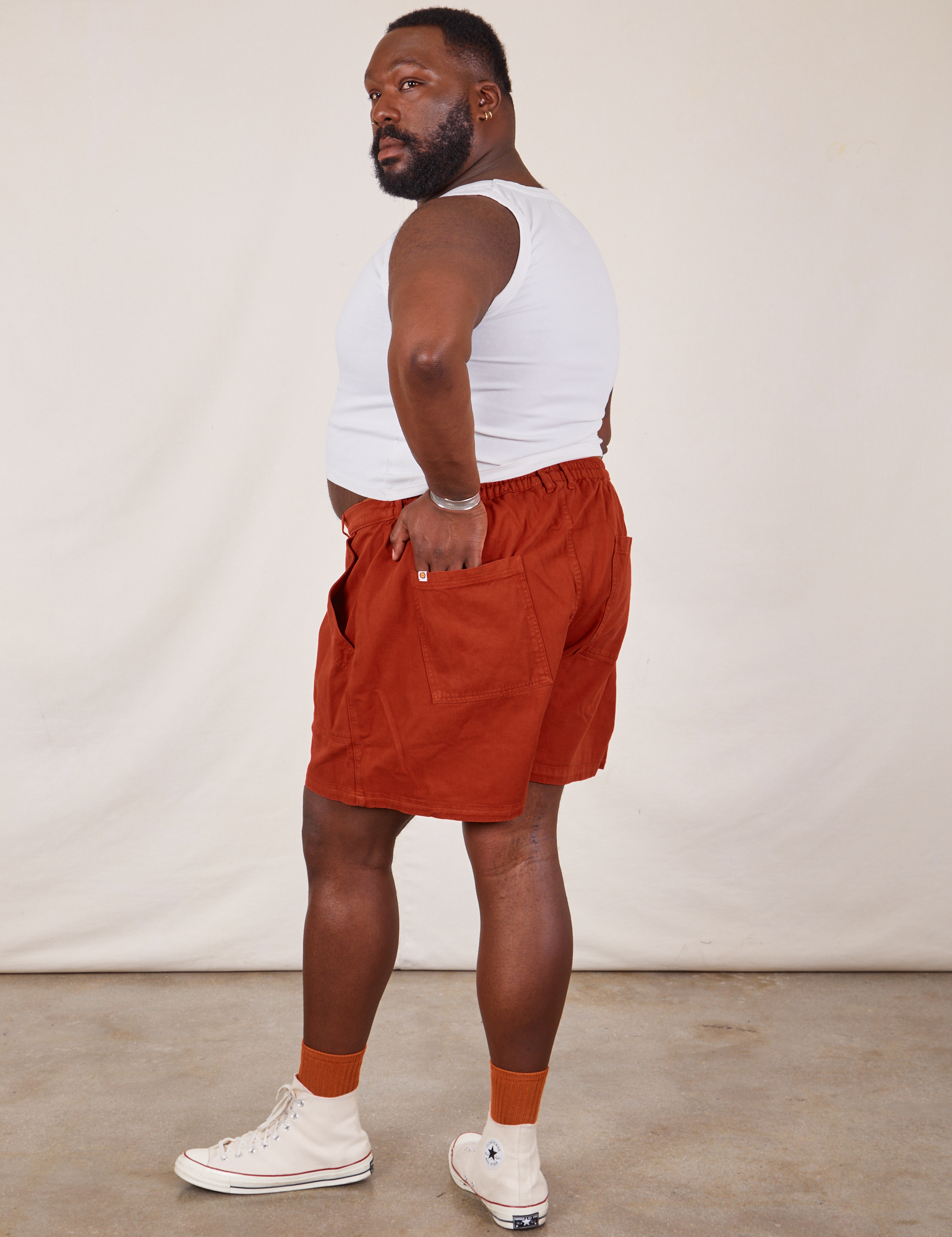 Angled back view of Classic Work Shorts in Paprika and Cropped Tank Top in vintage tee off-white on Elijah