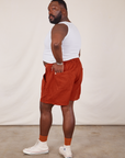Angled back view of Classic Work Shorts in Paprika and Cropped Tank Top in vintage tee off-white on Elijah