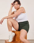 Tiara is wearing Classic Work Shorts in Swamp Green and a Cropped Tank Top in vintage tee off-white