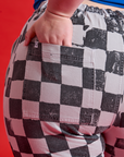 Close up of Ashley's hand in the pocket of Checkerboard Work Pants in Black/White