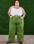 Sam is wearing Overdyed Wide Leg Trousers in Gross Green and Cropped Cami in vintage tee  off-white