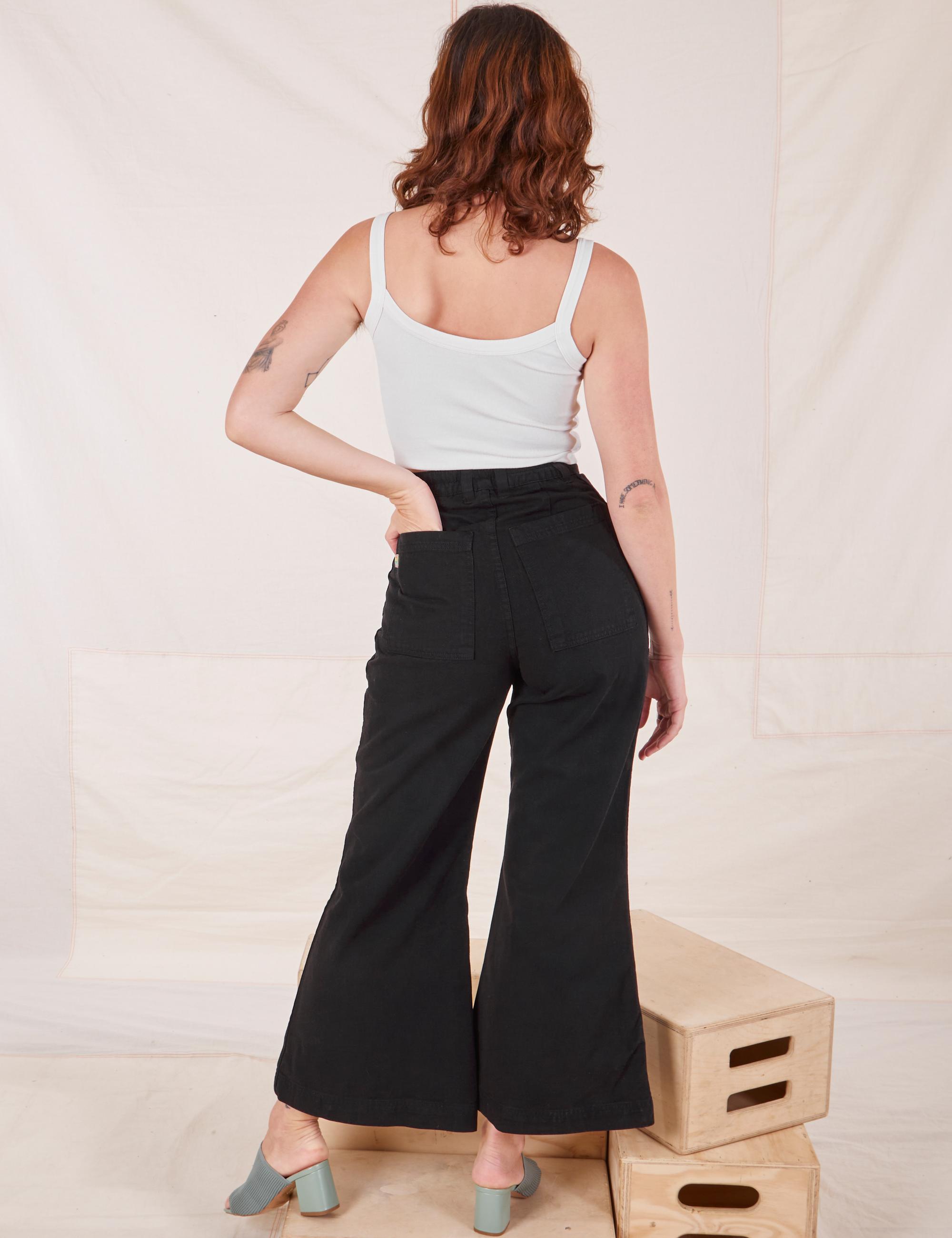 Back view of Bell Bottoms in Basic Black and Cropped Cami in vintage tee off-white on Alex