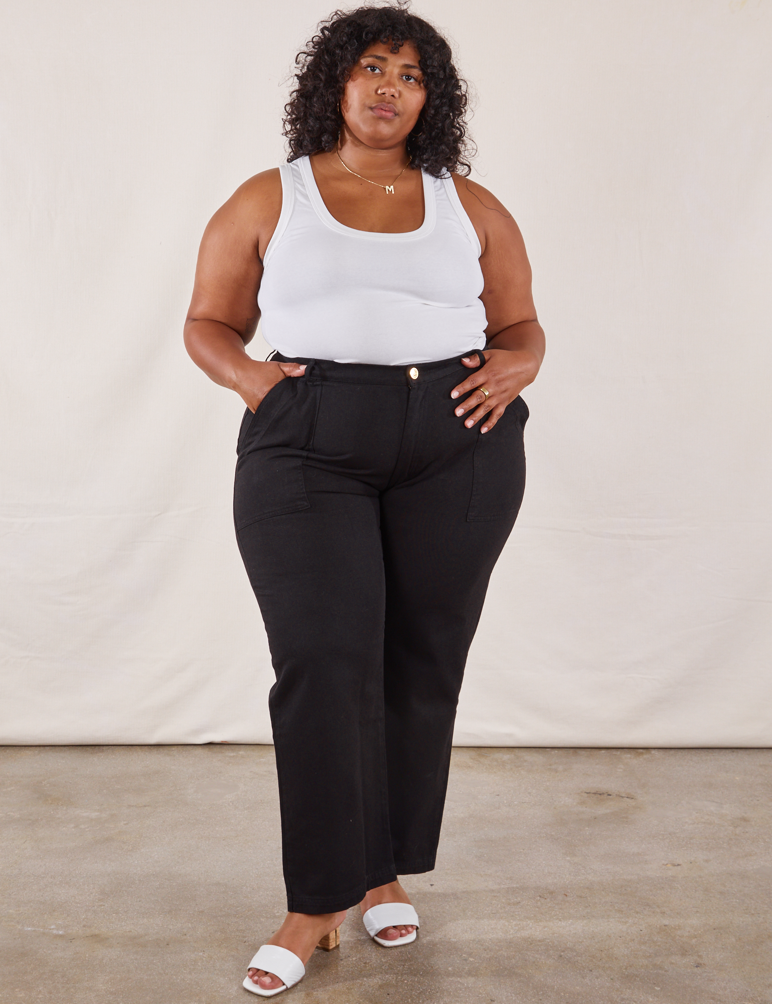 Morgan is 5'5" and wearing 3XL  Work Pants in Black paired with a Tank Top in vintage tee off-white
