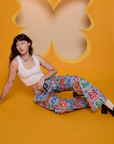 Alex is wearing Butterfly Kaleidoscope Drop Pocket Cargo Pants and vintage tee white Cropped Tank