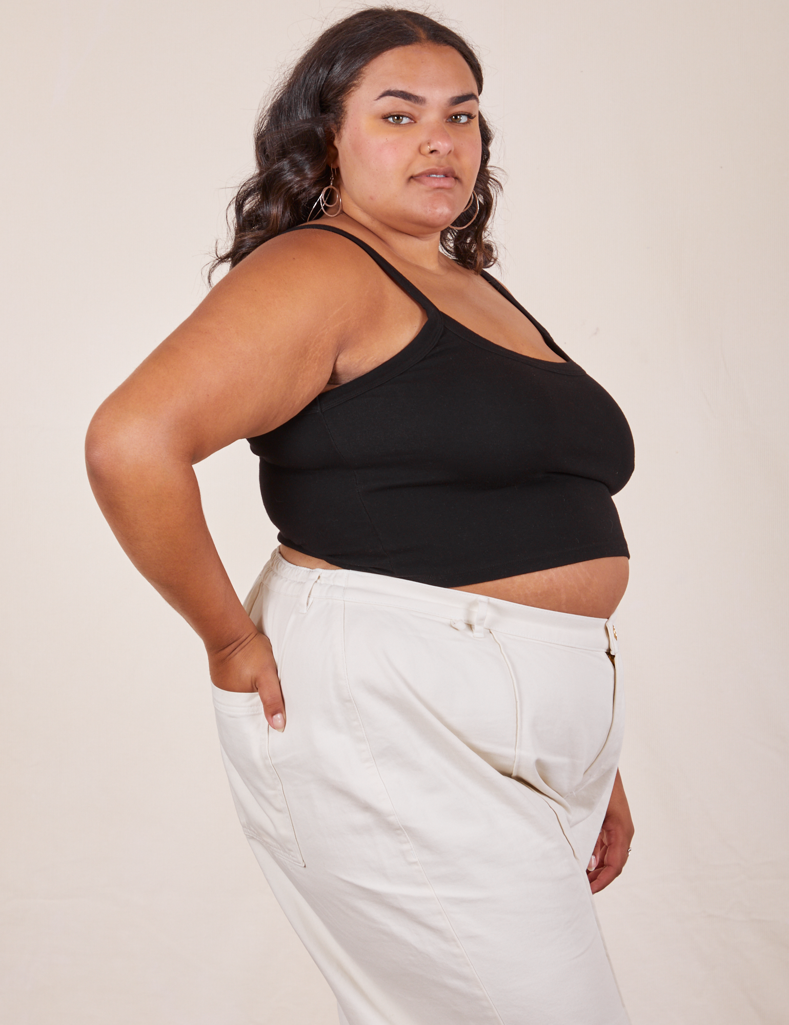 Side view of Cropped Cami in Basic Black and vintage tee off-white Western Pants worn by Alicia