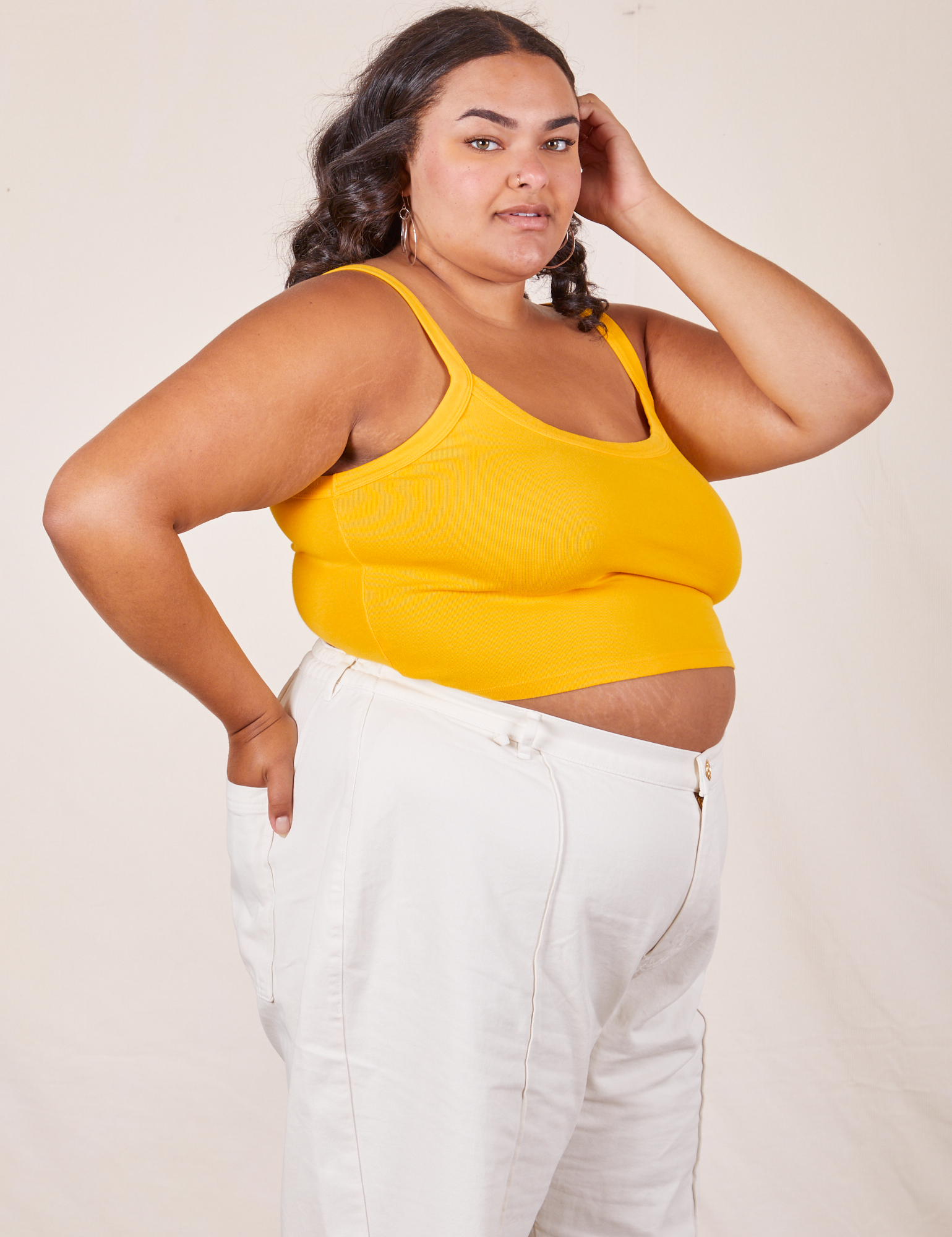 Angled view of Cropped Cami in Sunshine Yellow and vintage tee off-white Western Pants worn by Alicia