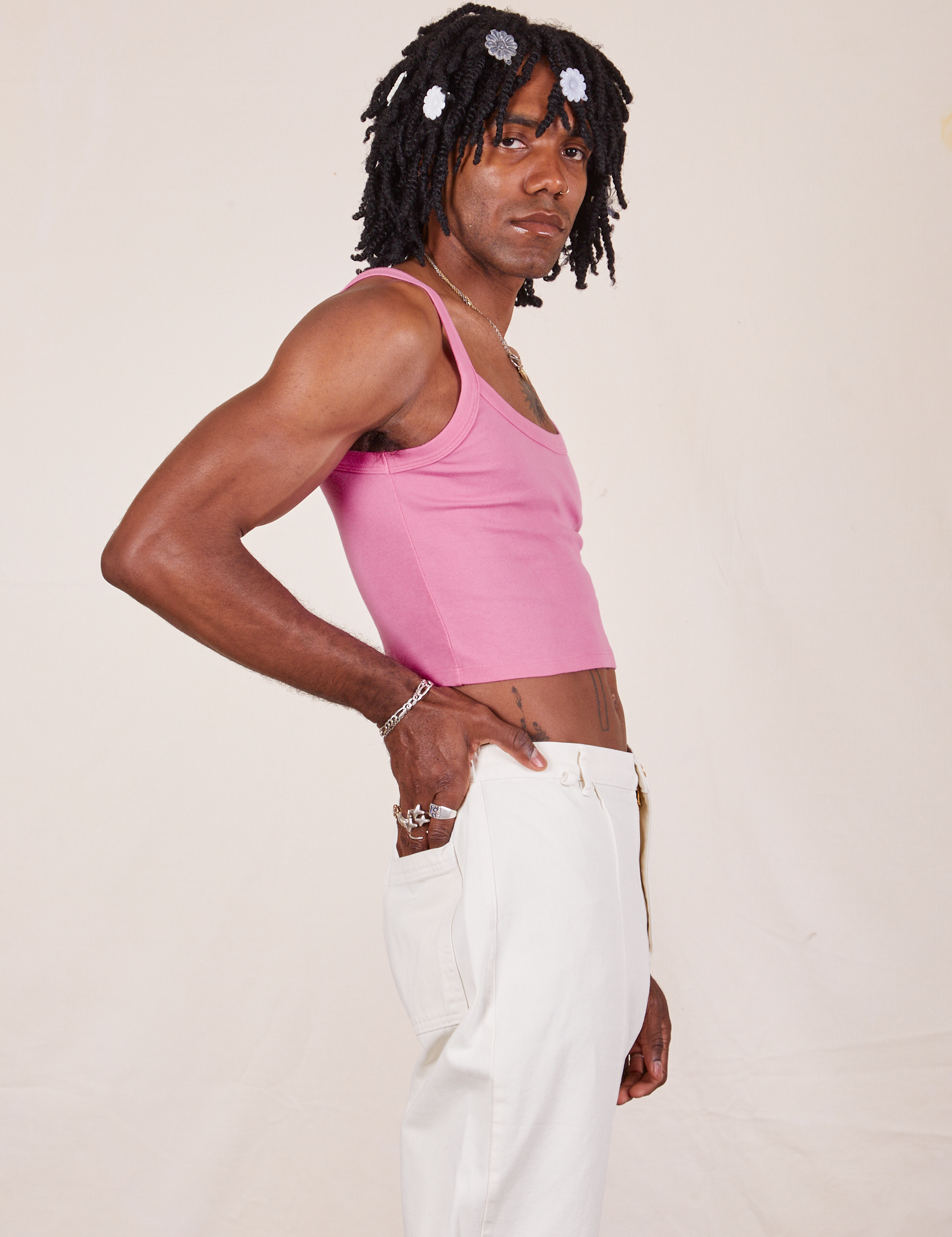 Side view of Cropped Cami in Bubblegum Pink and vintage tee off-white Western Pants worn by Jerrod