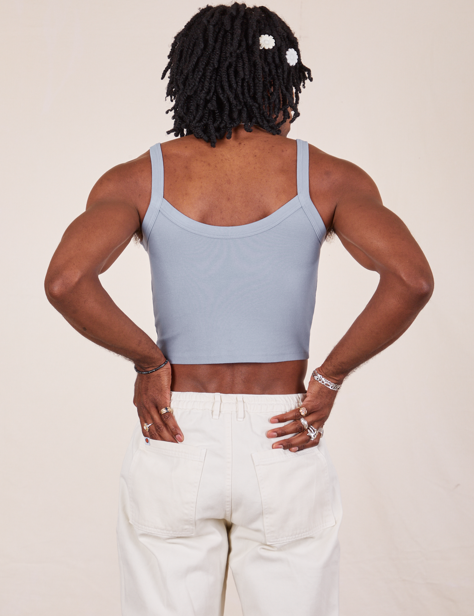 Back view of Cropped Cami in Periwinkle and vintage tee off-white Western Pants worn by Jerrod