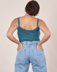 Back view of Cropped Cami in Marine Blue and light wash Sailor Jeans worn by Tiara. She has her hands in both back pant pockets.