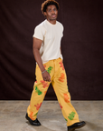 Angled front view of Gummy Bear Paintstamped Work Pants in Butter Yellow and Organic Vintage Tee in Vintage Off-White