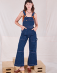 Alex is 5'8" and wearing XXS Carpenter Overalls in Dark Wash
