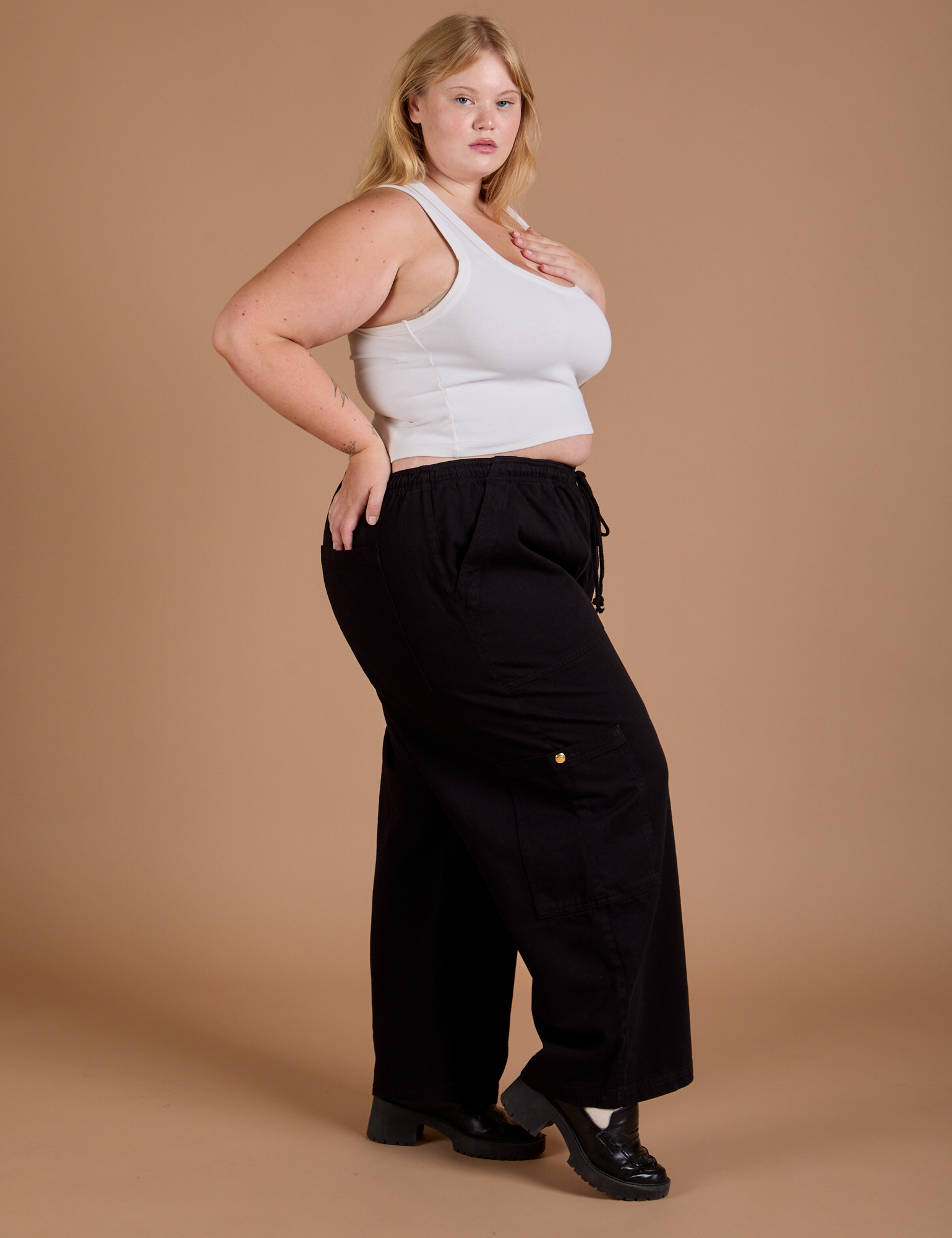 Side view of Drop Pocket Cargo Pants in Basic Black and Cropped Tank in vintage tee white on Juliet