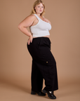 Side view of Drop Pocket Cargo Pants in Basic Black and Cropped Tank in vintage tee white on Juliet