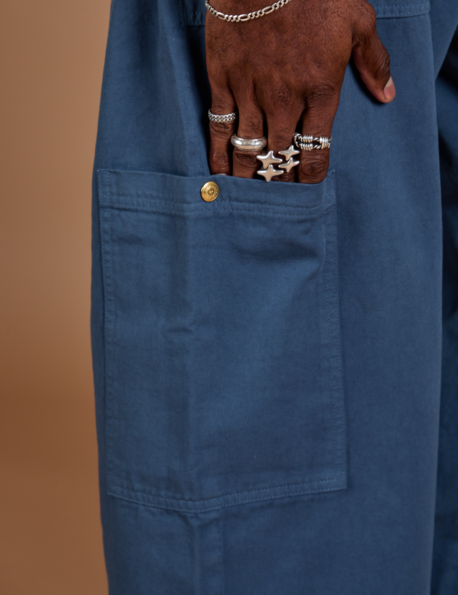 Close up of Jerrod's hand tucked into the side pant leg pocket