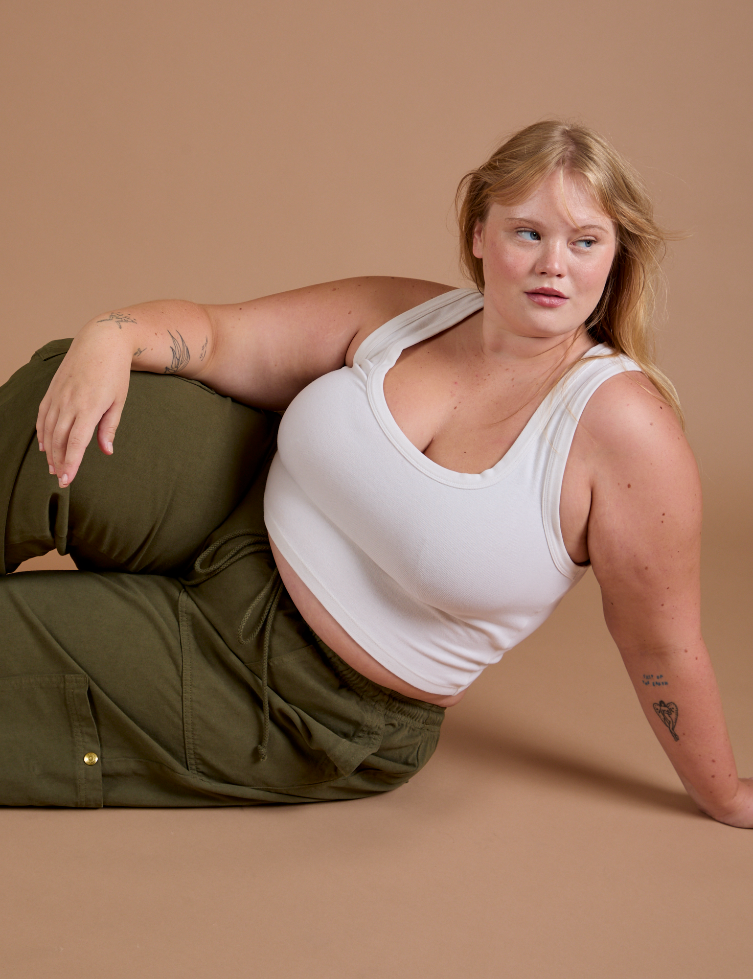 Juliet has on Drop Pocket Cargo Pants in Surplus Green and Cropped Tank in vintage tee white