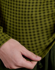 Bottom close up of Gingham Long Sleeve Baby Tee in Summer Olive on Alex