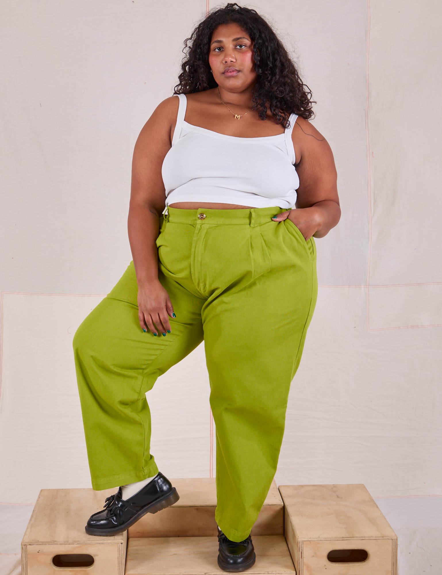 Morgan is wearing Heavyweight Trousers in Gross Green and Cami in vintage tee off-white