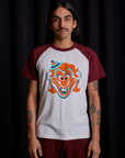 Anthony is 5'6" and wearing S Raglan Tee in Clown