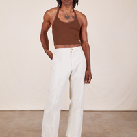 Jerrod is wearing Halter Top in Fudgesicle Brown and vintage off-white Western Pants