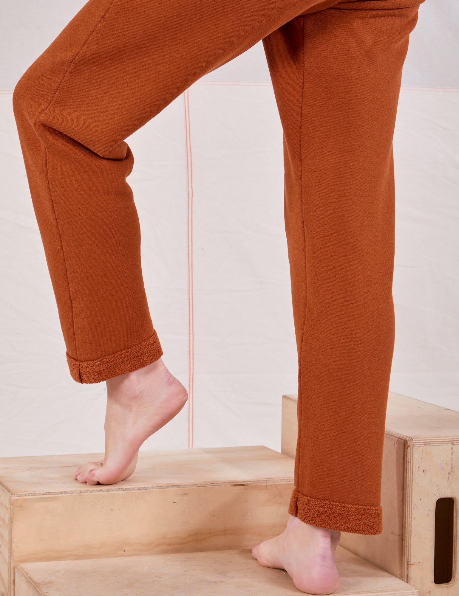 Rolled Cuff Sweat Pants in Burnt Terracotta pant leg close up on Alex