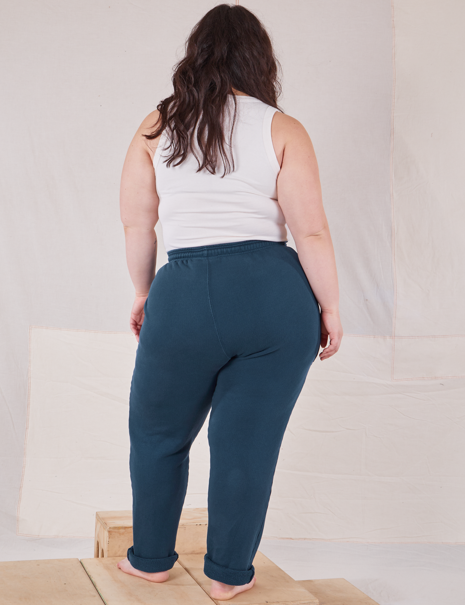Back view of Rolled Cuff Sweat Pants in Lagoon and vintage off-white Cropped Tank on Ashley