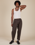 Jerrod is 6'3" and wearing M Heavyweight Trousers in Espresso Brown paired with a Tank Top in Vintage Tee Off-White