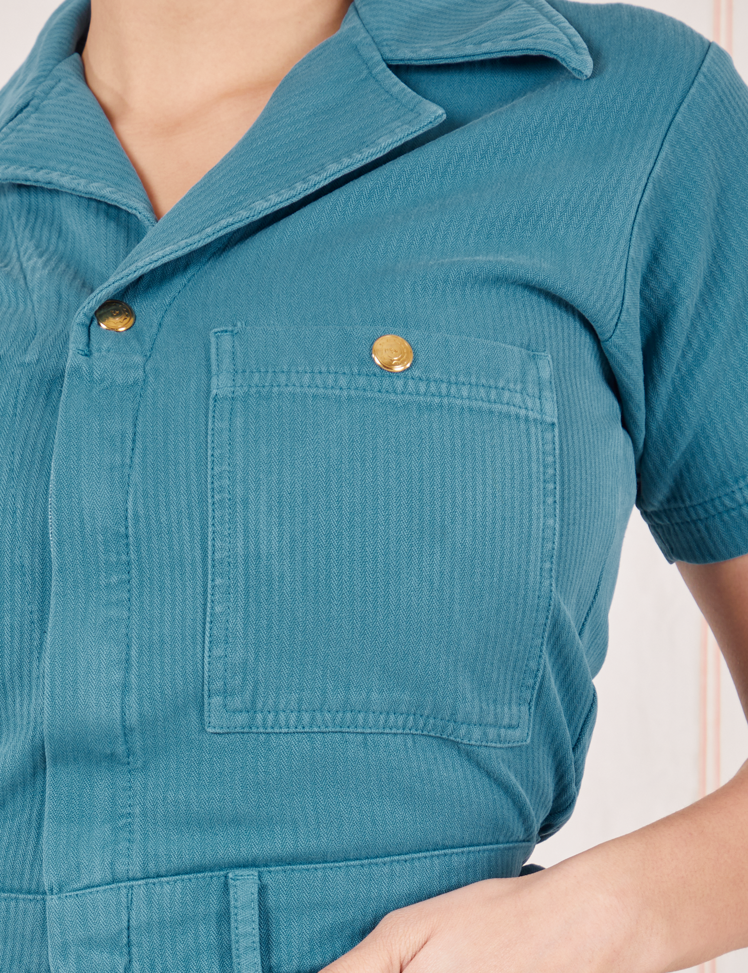 Front pocket close up of Heritage Short Sleeve Jumpsuit in Marine Blue worn by Tiara