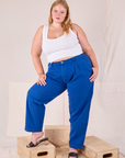 Juliet is 5’7” and wearing 0XL Heritage Trousers in Royal Blue paired with a Cropped Tank in vintage tee off-white