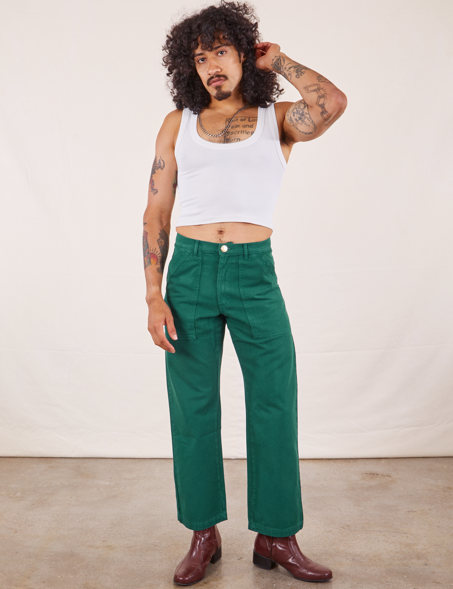Jesse is 5&#39;8&quot; and wearing XS Work Pants in Hunter Green paired with vintage off-white Tank Top