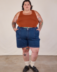 Sam is 5'10" and wearing 3XL Carpenter Shorts in Dark Wash paired with burnt terracotta Cropped Tank