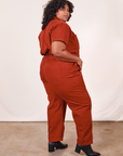 Angled side view of Short Sleeve Jumpsuit in Paprika worn by Morgan