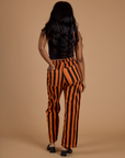Back view of Black Stripe Work Pants in Construction Orange on Kandia