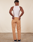 Back view of Long Work Pants in tan and wearing paired with Tank Top in vintage tee off-white worn by Jerrod