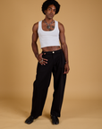 Jerrod is 6'3" and wearing M Baggy Mid-Rise Trousers in Basic Black paired with a vintage tee white Cropped Tank