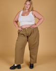 Juliet is wearing Baggy Mid-Rise Trousers in Desert Brown and vintage tee white Cropped Tank