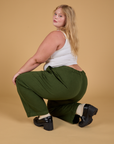 Angled back view of Baggy Mid-Rise Trousers in Evergreen on Juliet