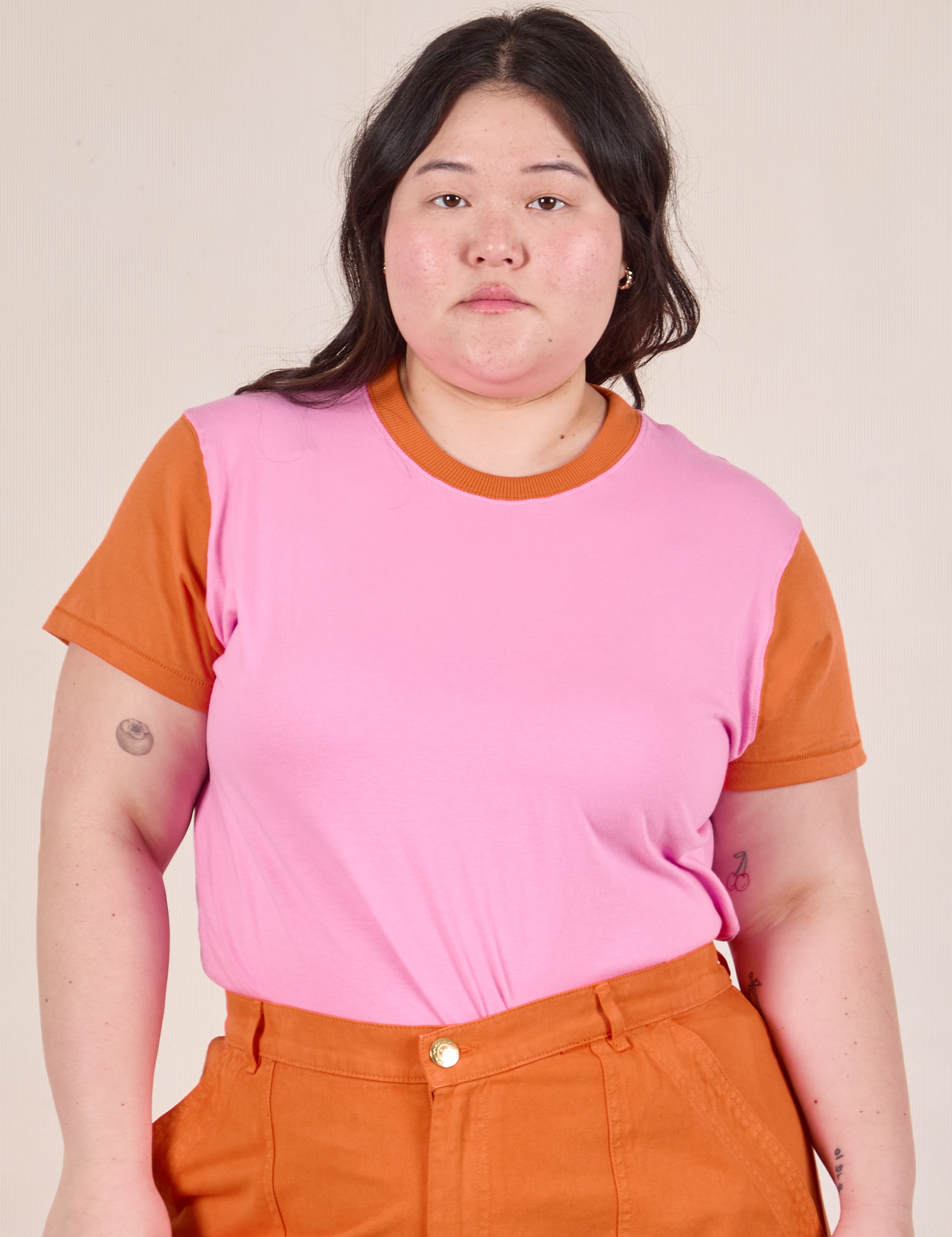 Ashley is 5’7” and wearing L Mismatched Tee in Pink & Orange
