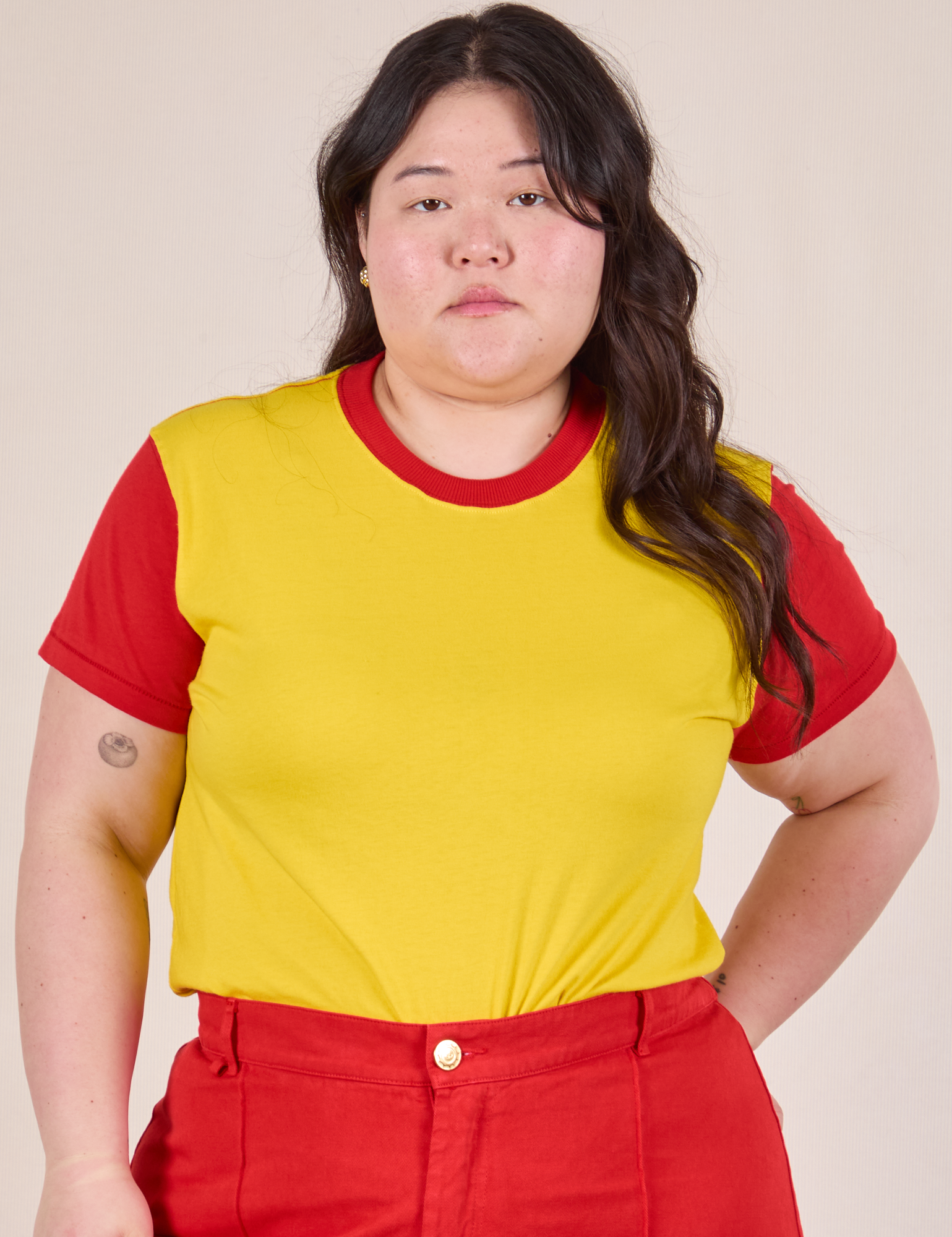 Ashley is 5’7” and wearing L Mismatched Tee in Yellow & Red