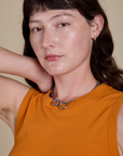 Front close up of Muscle Tee in Creamsicle Orange on Alex