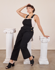 Tiara is wearing Original Overalls in Mono Black and Cropped Tank Top in vintage tee off-white underneath.