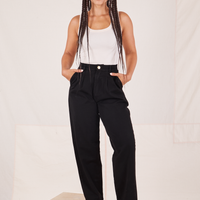 Gabi is 5'7" and wearing XXS Organic Trousers in Basic Black paired with vintage off-white Tank Top