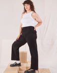 Side view of Organic Work Pants in Basic Black and Racerback Tank in vintage tee off-white on Ryan