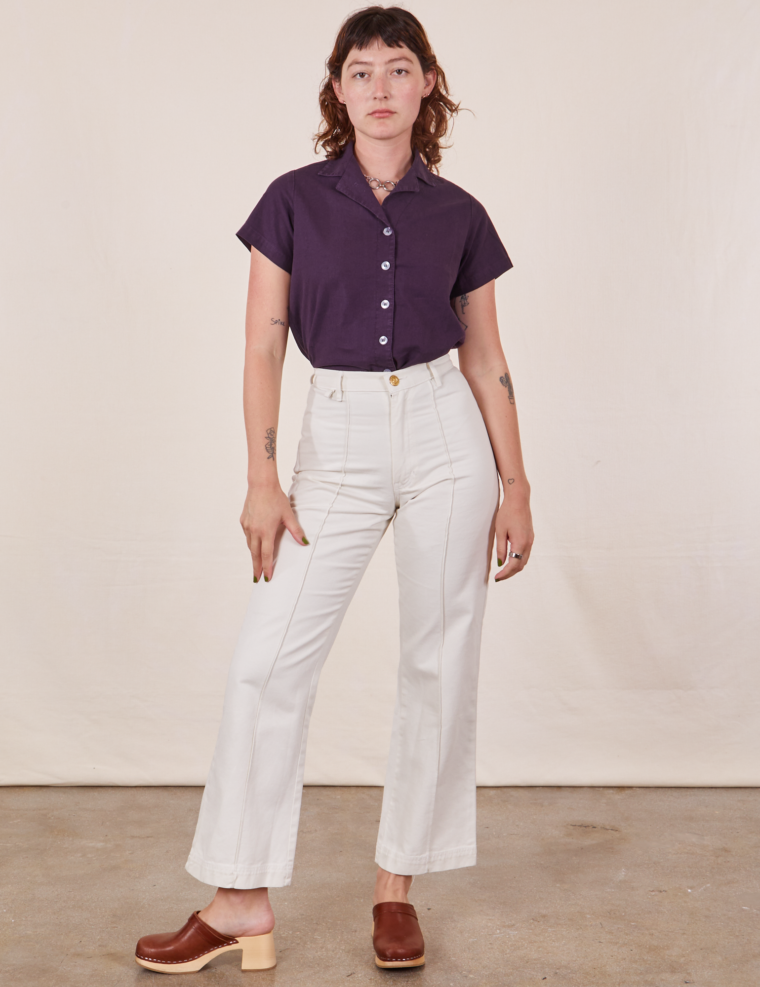 Alex is wearing Pantry Button-Up in Nebula Purple tucked into vintage tee off-white Western Pants