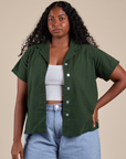Meghna is 5’8” and wearing M Pantry Button-Up in Swamp Green