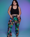 Ashley is 5'7" and wearing 1XL Work Pants in Rainbow Magic Waters paired with a black Cropped Tank