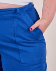 Work Pants in Royal Blue front pocket close up with Juliet's hand in the pocket